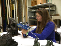 Johanna Salvant, a postdoctoral fellow at NU-ACCESS, examines a sculpture with a handheld, non-invasive X-ray machine developed at the center. (Credit: NU-ACCESS)