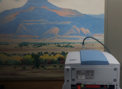 Landscape painting with a scanner in the foreground