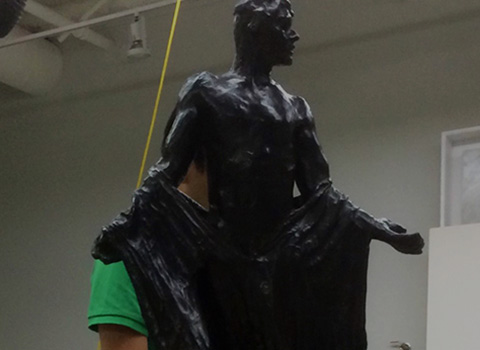 A bronze sculpture of a man in a robe