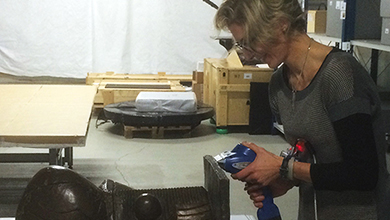 Musee National Picasso-Paris curator Virginie Perdrisot uses a handheld X-ray fluorescence scanner to analyze its elemental composition.