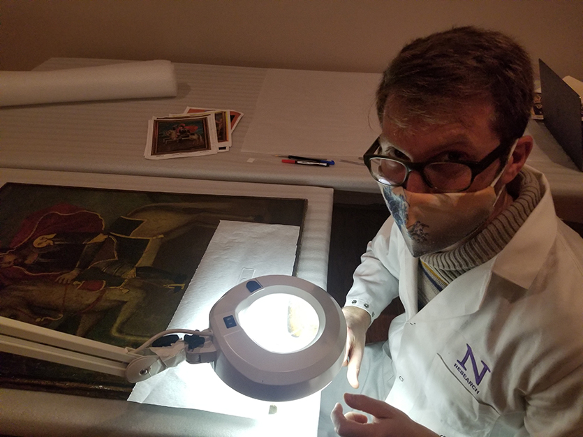 Center post-doctoral fellow Marc Vermeulen examines St. James the Elder, by an unknown early 19th-century artist, the National Museum of Mexican Art.